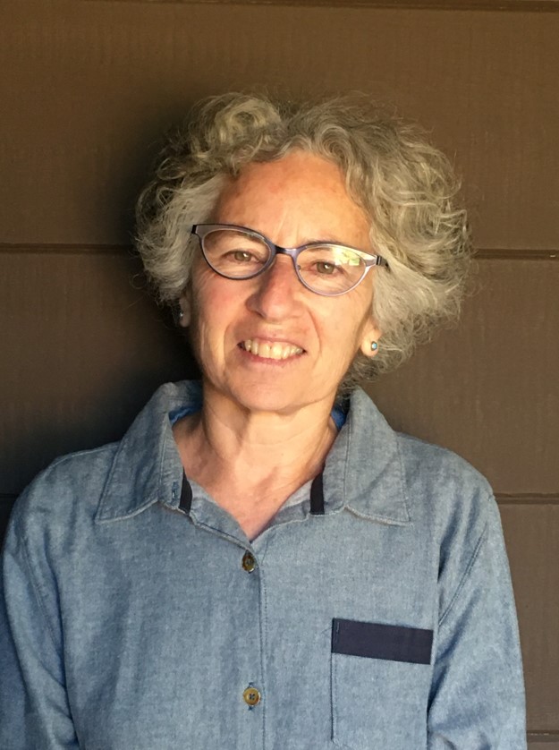 Photo of Susan Frankel - a smiling woman with wavy grey hair and glasses